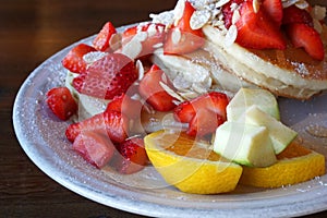 American Dessert - Pancake banana and strawberry fruit with honey caramel - Closeup scene - Breakfast food on coffee cafe