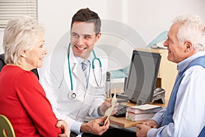 American doctor talking to senior couple