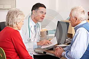 American doctor talking to senior couple