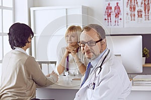 American doctor talking to woman in surgery