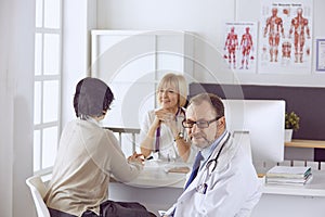 American doctor talking to woman in surgery