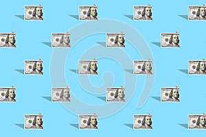 . American dollar banknotes on a bright blue background. Pattern. The concept of different financial transactions
