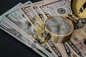 American dollar Banknotes and compass / business direction concept