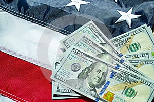 American dollars banknotes on the flag of United States. US dollars background. 100 USD