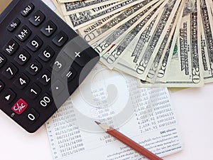 American Dollars cash money, calculator on savings account passbook or financial statement