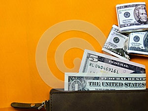 American dollars on orange bright background photo