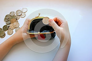 American dollars in a coin purse on a white background. Close-up of the hand.