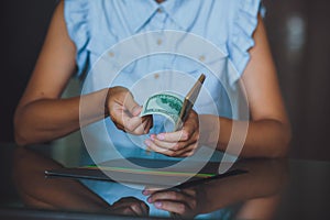 American dollars in the hands, women counting money