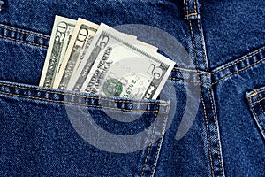 American dollars in jeans pocket background. Cash, money is in the pocket of blue jeans