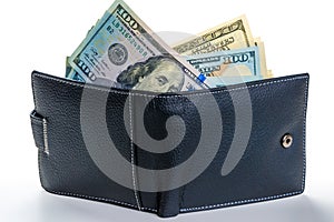 American dollars sticking out of a leather wallet full