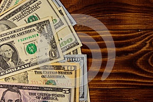 American dollars on wooden background. Top view, copy space