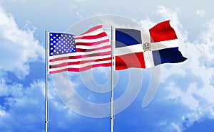 American and Dominican Republic flags together waving against blue sky