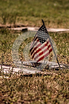 American fag waving in the breeze at a cemetery in Monmouth Oregon by gravestones