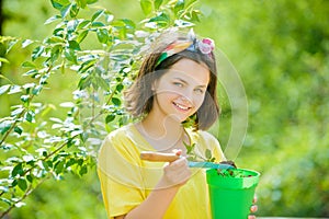 American farm life. Daughter grows flowers, potted. Happy little gardener with spring flowers. Little girl with pot