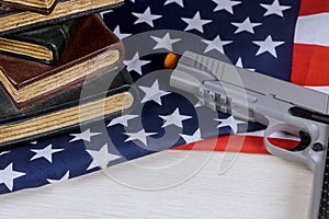 American firearm handgun lying on US flag with school shooting gun