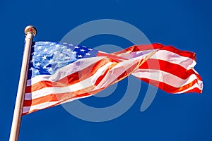 American Flag against blue sky.