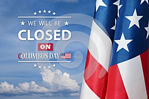 American flag on background of blue sky with a message. We will be Closed on Columbus Day.