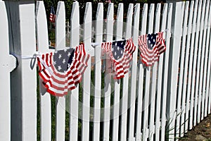 American flag banners on white picket fence, america the beautiful