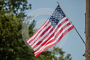 American Flag Blowing in the Wind. Background in Bokeh