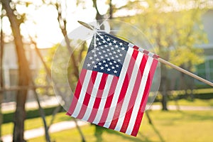 American flag with bokeh natural background and sunlight for Memorial Day or 4th of July.