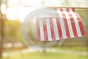 American flag with bokeh natural background and sunlight for Memorial Day or 4th of July.