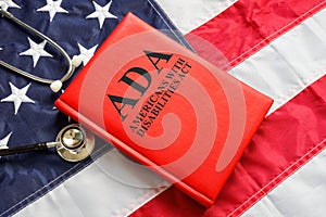 American flag, book The Americans with Disabilities Act ADA law and stethoscope.