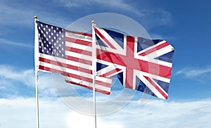 American flag and British flag on cloudy sky. waving in the sky