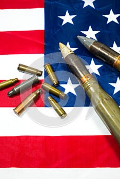 American flag with bullets, shells, cartridges and projectiles on it. Lend-Lease concept.  Army concept. Sales of weapons and