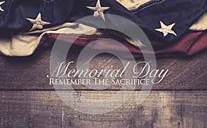 An American flag or bunting on a wooden background with memorial day greeting