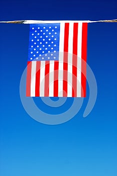 American flag with clear sky in the background.