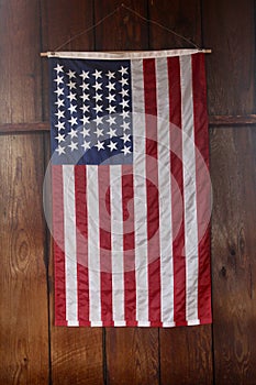 American Flag close up hanging vertically on wood wall