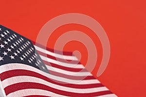 American flag close up on red background with copy space. Patriotism, symbol, background, concept