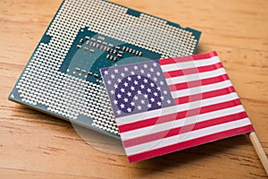 American flag on CPU computer (central processing unit) wooden background. photo