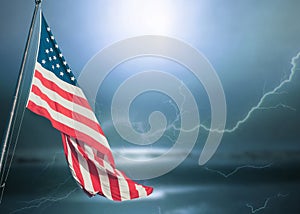 American flag on dark blue stormy sky.