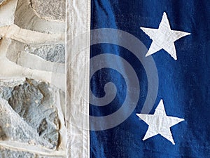 American flag detail against interior stone house wall