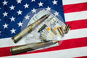 American flag with dollars money, bullets, shells, cartridges and projectiles on it. Lend-Lease concept.  Army concept. Sales of