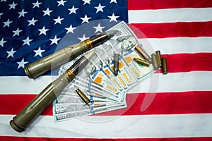 American flag with dollars money, bullets, shells, cartridges and projectiles on it. Lend-Lease concept.  Army concept. Sales of