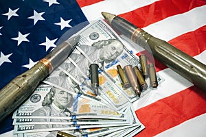 American flag with dollars money, bullets, shells, cartridges and projectiles on it. Lend-Lease concept.  Army concept. Sales of