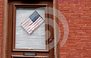 American flag on a door of the house in New York, USA