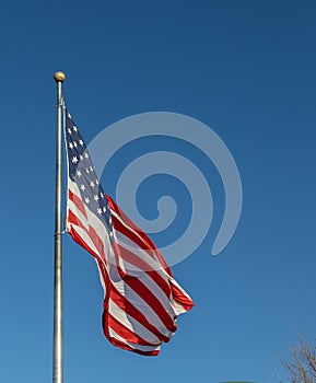 American flag on flagpole with blue sky