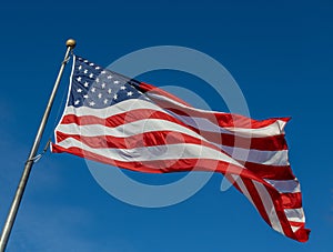 American flag on flagpole with blue sky