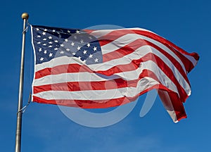 American flag on flagpole with blue sky