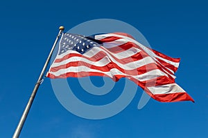 American flag on flagpole with blue sky