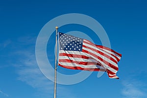 American flag on flagpole with blue sky