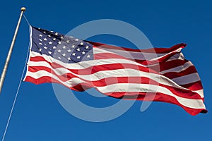 American flag on flagpole with blue sky