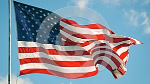 American flag flies in the sky with clouds, USA