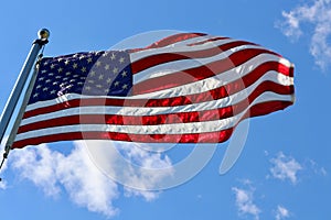 American flag flying in breeze from flagpole outdoors