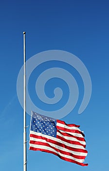 American flag flying at half staff in memory of Newtown massacre victims .