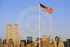 American Flag flying over skyline of New York City from New York Harbor, NY