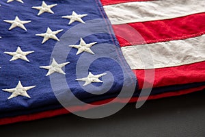 American flag folded on black abackground, US America National Holiday